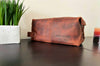 Distressed full grain leather travel bag with two color and two size options.